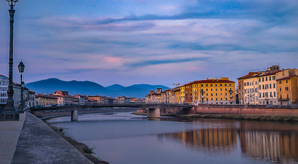 Pisa Tuscany on Arno river. the town lies beneath the Pisan mountains - bridge over the Arno